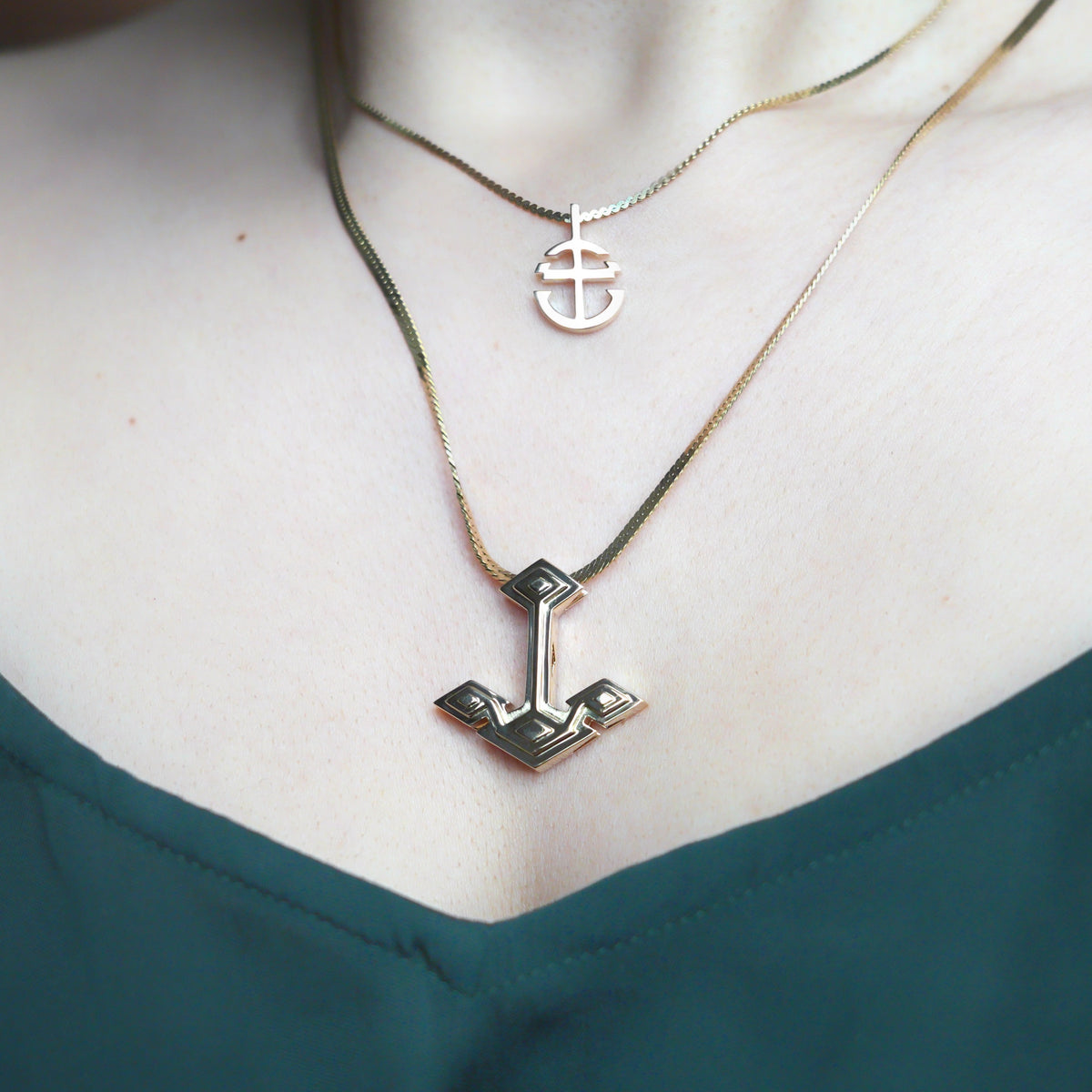 Core Anchor Pendant Solid 18K Yellow Gold rounded and Root Anchor Charm on model with emerald green silk shirt